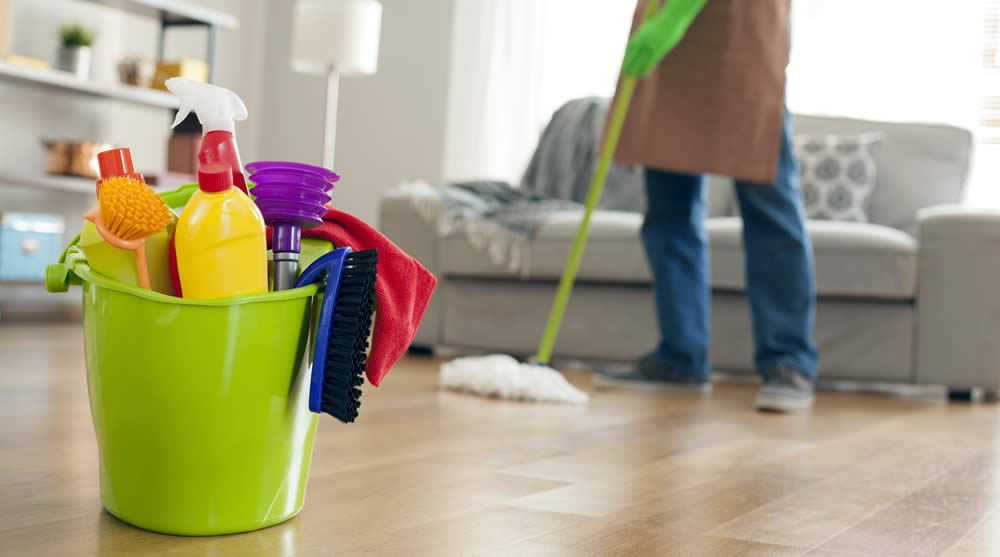 Home cleaning supplies and mop being used for residential cleaning service in Al Nuaimiya, Ajman